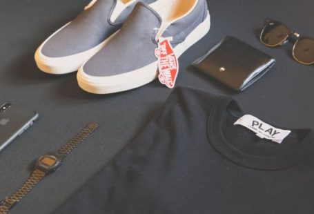 Branding - Pair of Gray Vans Low-top Sneakers Beside Black Shirt, Sunglasses, and Watch