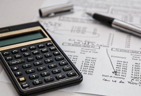 Budgeting - Black Calculator Near Ballpoint Pen on White Printed Paper