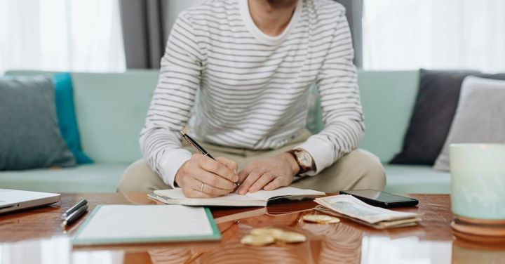 Budgeting - Man in White and Gray Striped Long Sleeve Shirt Sitting at the Table