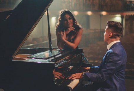 Workplace Culture - Man playing piano for woman