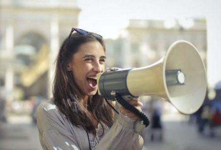 Marketing Campaigns - Cheerful young woman screaming into megaphone