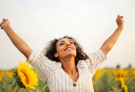 Success - Photo Of Woman Standing On Sunflower Field