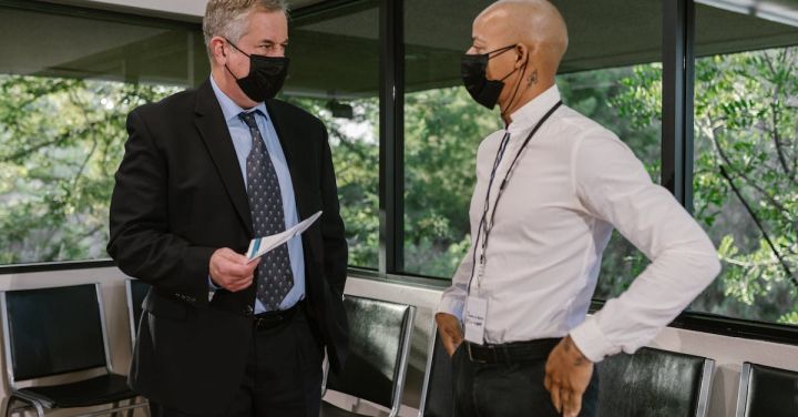 Business Events - People in Corporate Attire Talking with Their Face Mask On