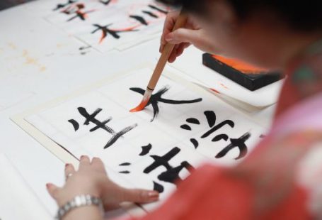 Up Graph - Person Holding Brush Drawing Kanji Script