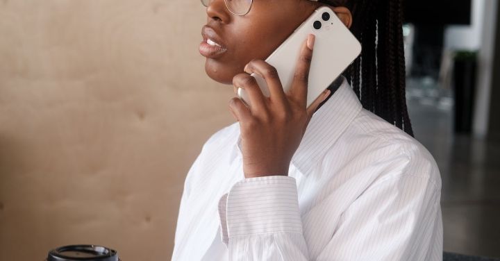 Professional Connections - Black businesswoman speaking on smartphone